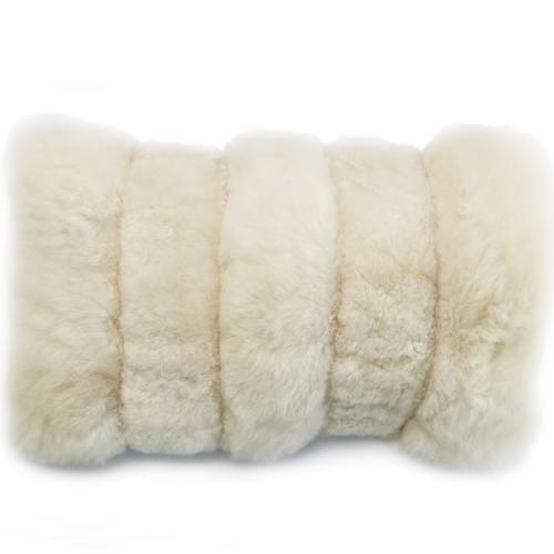 Close-up of a fluffy white alpaca fur lumbar pillow on a white background