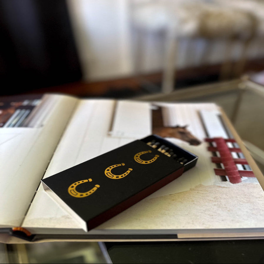 Black book with gold lettering on a table with blurred background