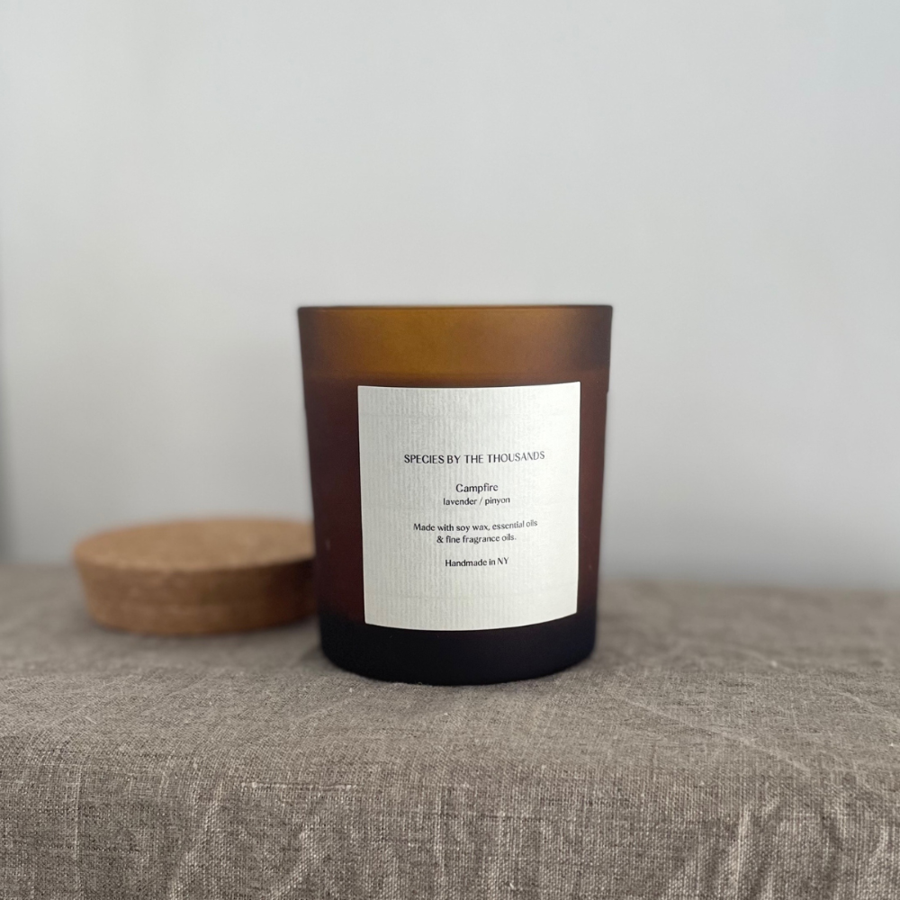 Candle with a label on a textured surface