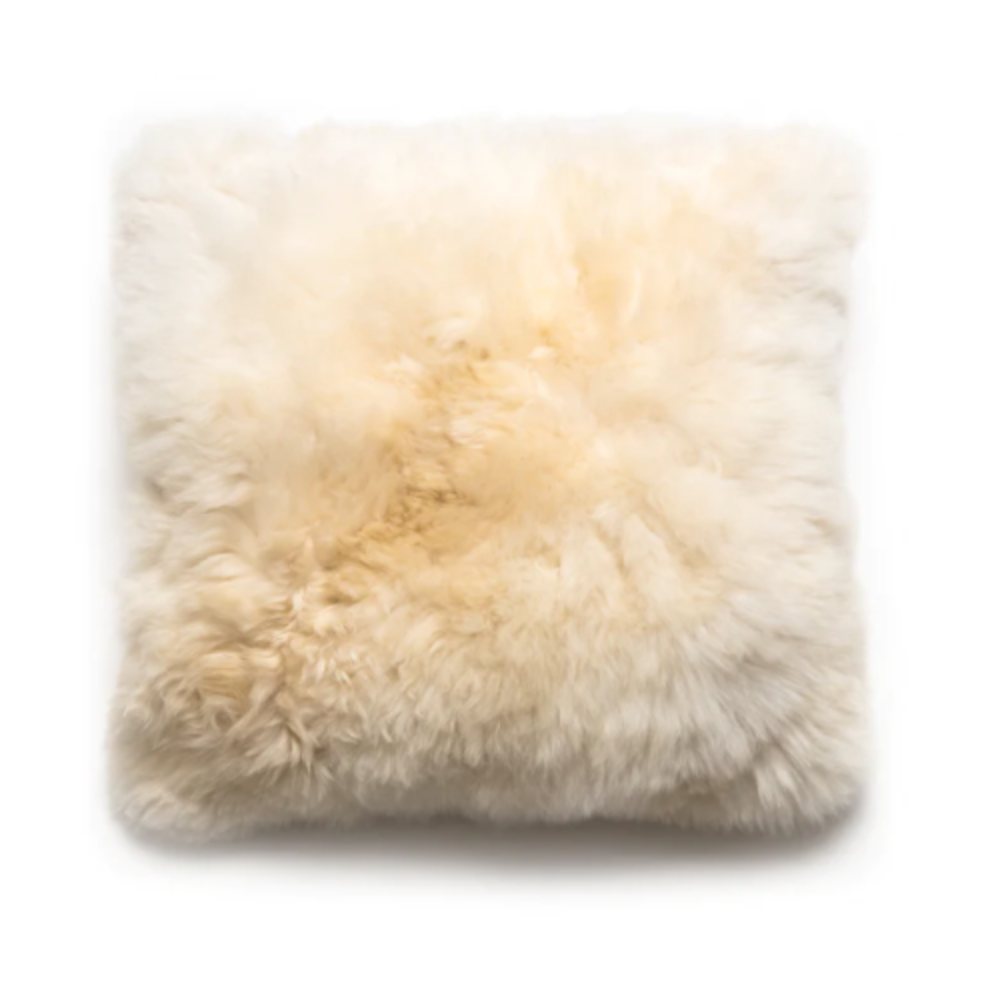 square alpaca pillow in cream on a white background