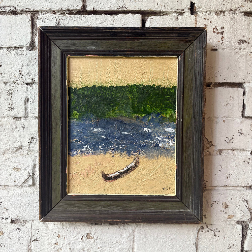 Framed painting of a landscape with a boat on a brick wall