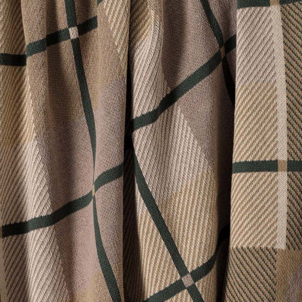 Close-up of a plaid fabric with brown and green patterns