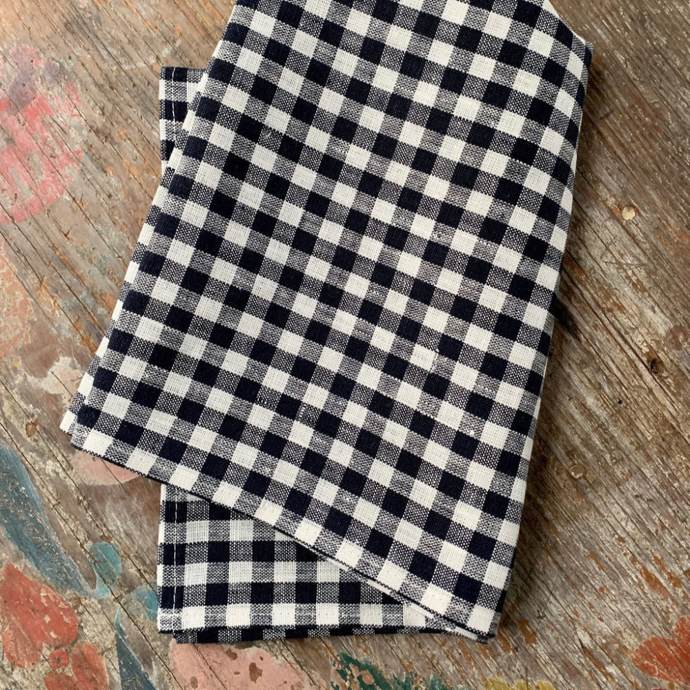 Black and white checkered kitchen towel on a wooden surface