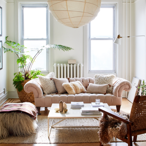 alpaca lumbar throw pillow presented in a living room among other throw pillows