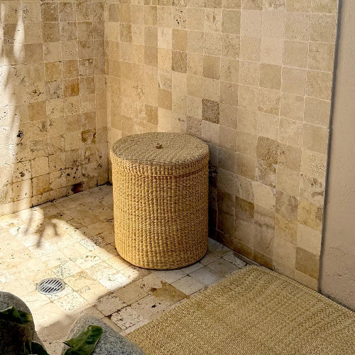 Woven basket in a shower with tiled walls