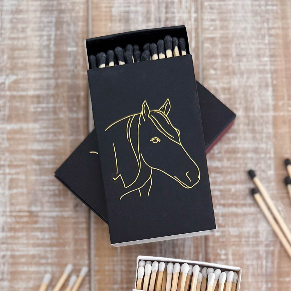 Matches with horse illustrations on a wooden surface