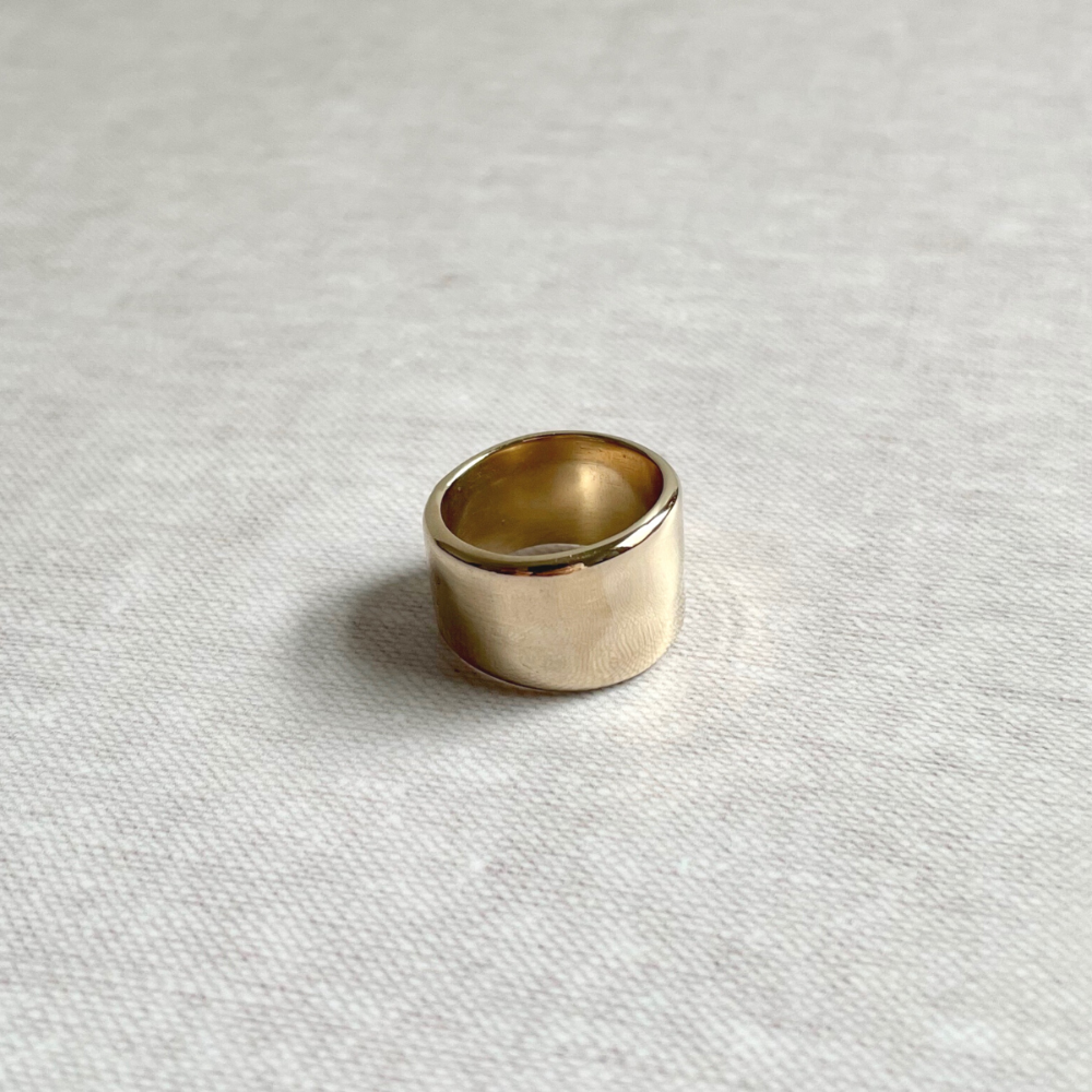 Brass ring on a textured white surface
