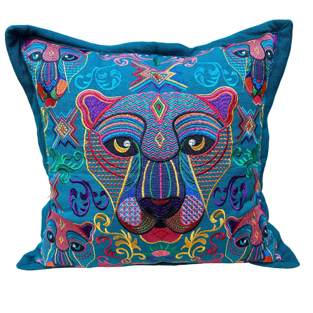 A square decorative throw pillow featuring a highly detailed, colorful embroidered panther face and smaller matching panthers in a bohemian style, set against a teal background
