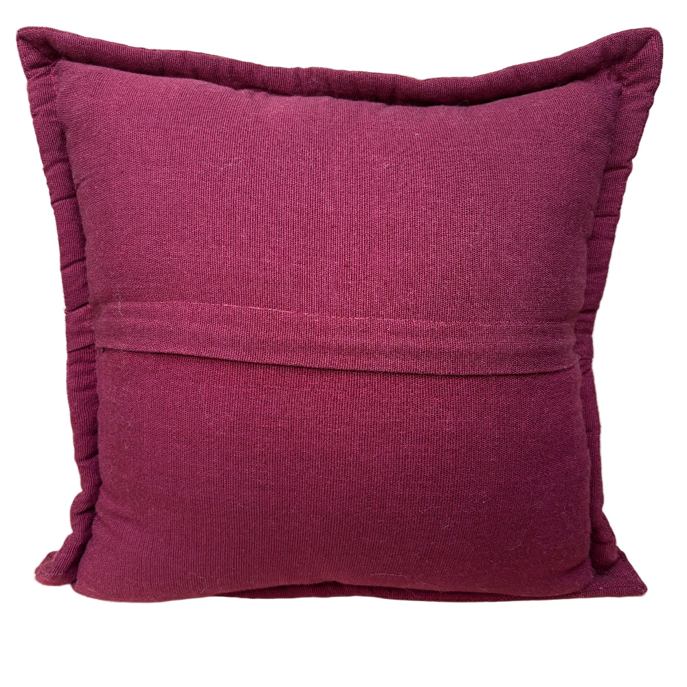 A square throw pillow in a deep magenta fabric, featuring zipper closure stitched seam across the center and a flange border