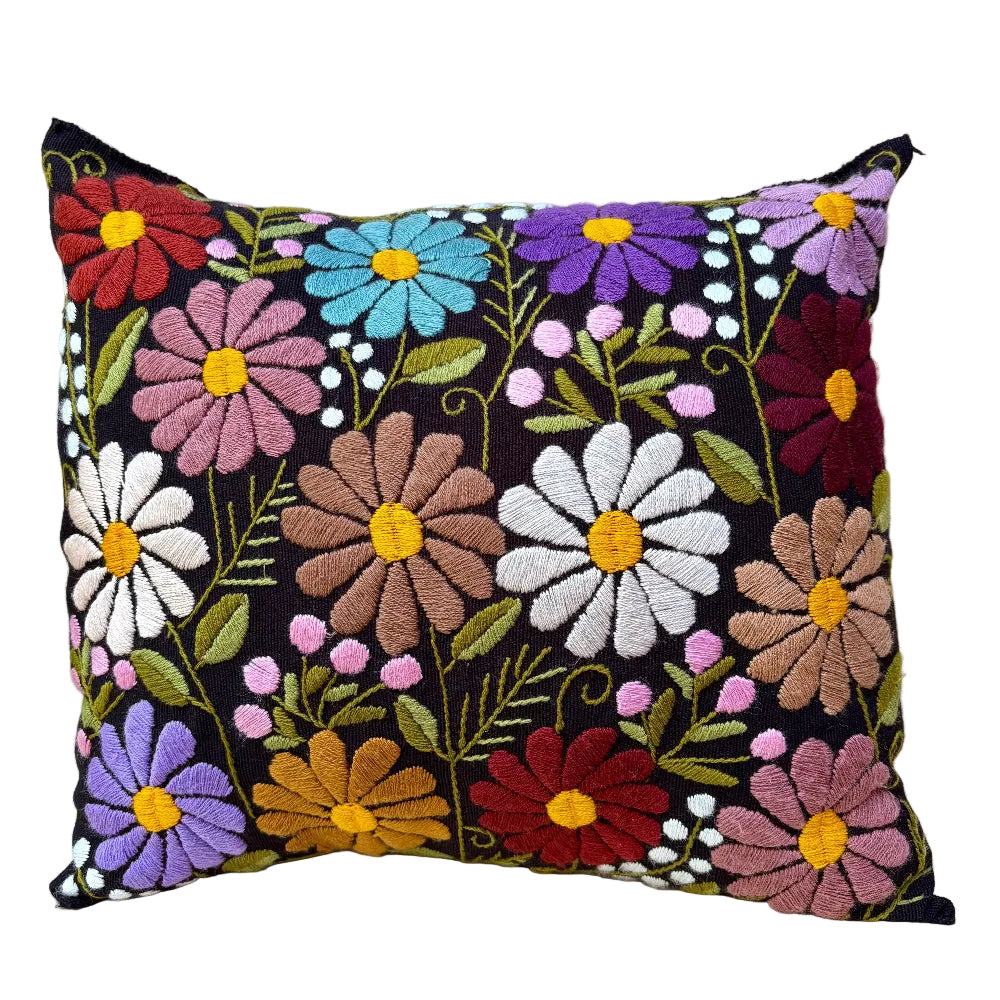 A square decorative throw pillow with a black background and colorful embroidered flowers