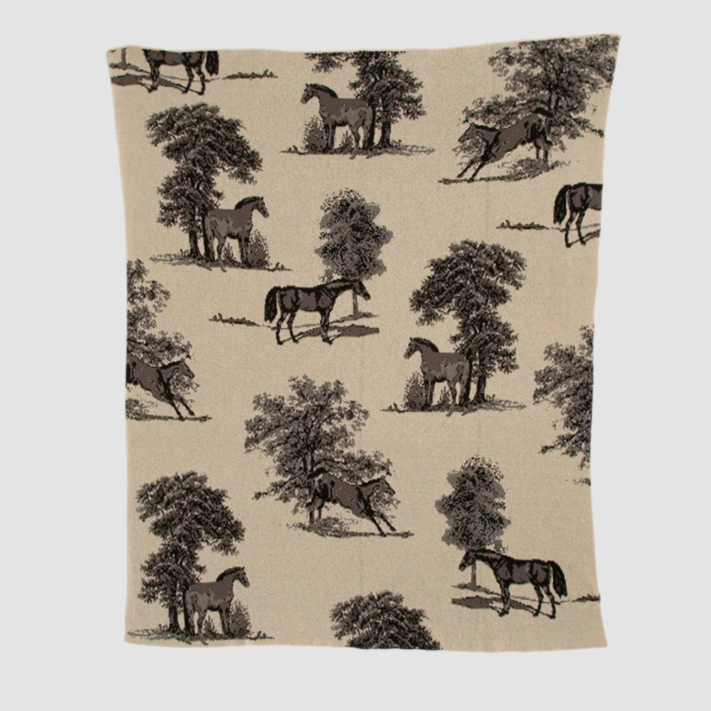 Beige blanket with black horse and tree pattern