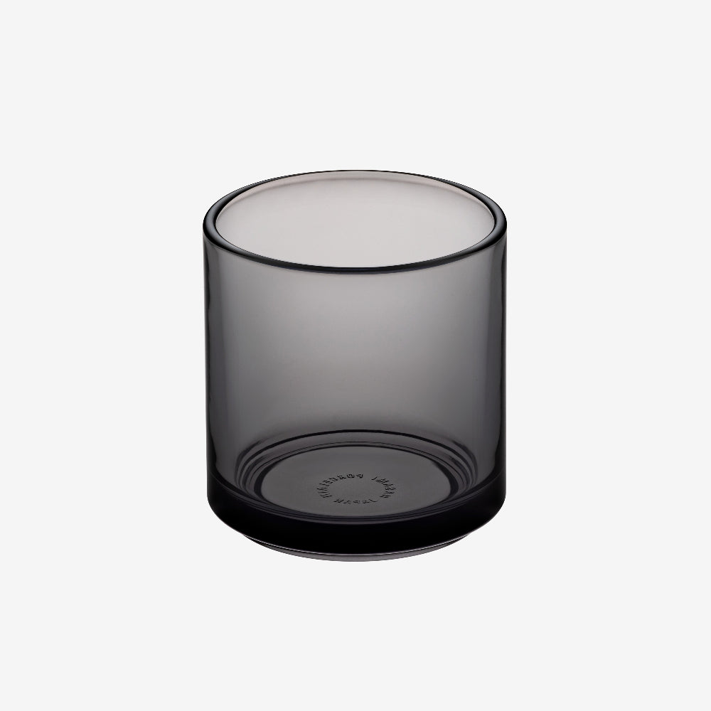 Smoky gray glass tumbler on a white background