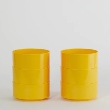 Three yellow Hellerware Max bowls stacked on a light gray background