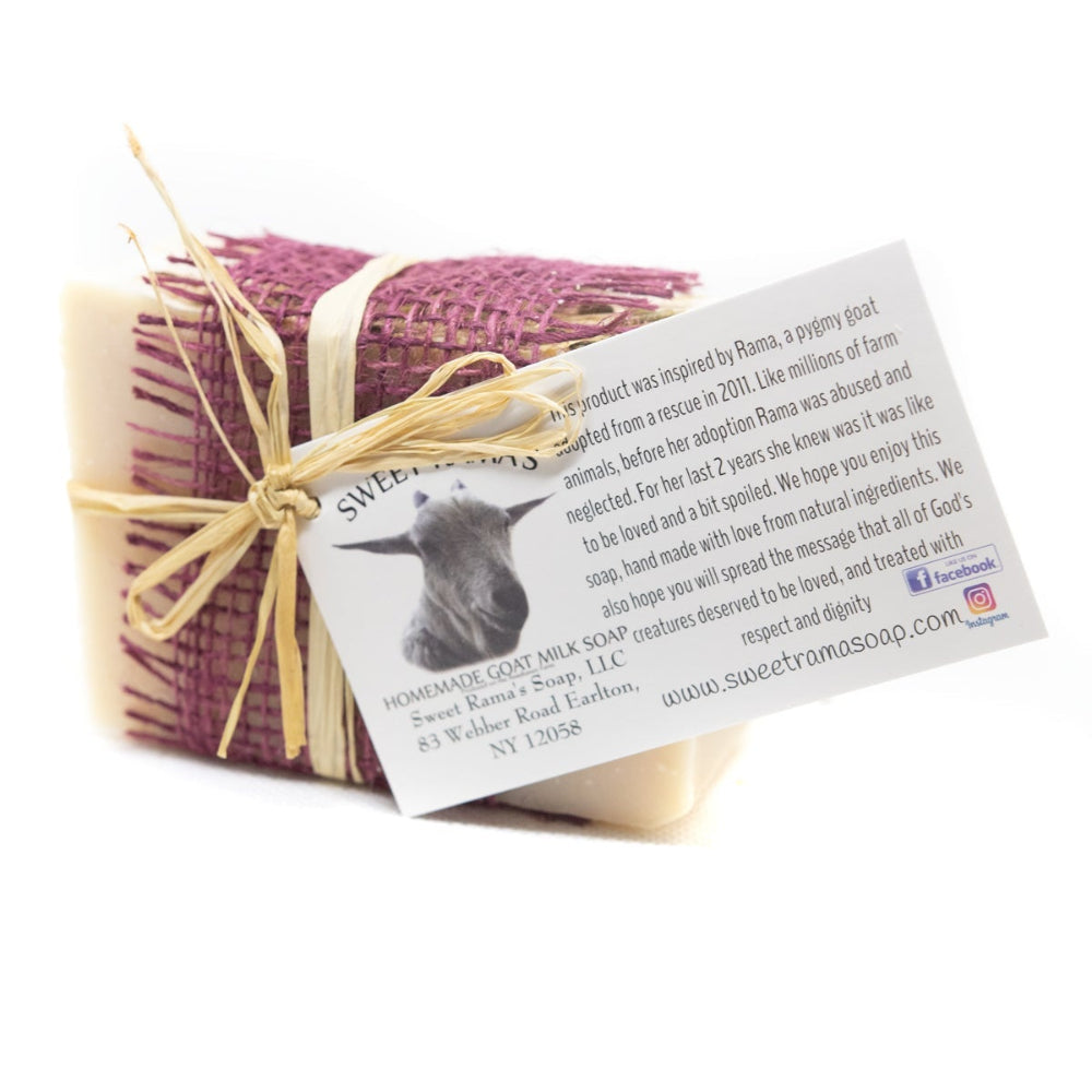 Bar of soap wrapped in purple paper with a yellow ribbon on a white background