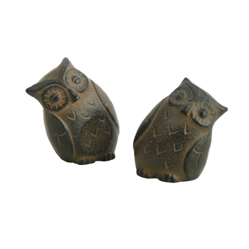 Two bronze owl figurines on a white background