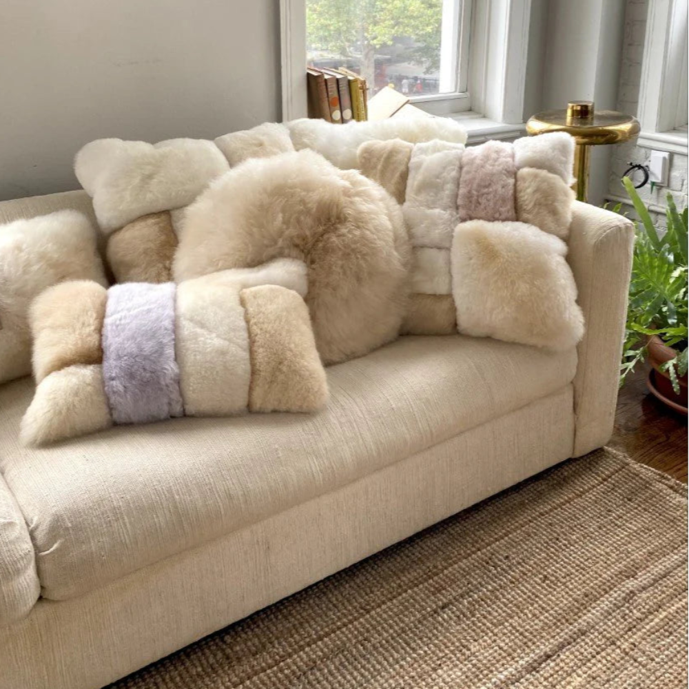 Beige sofa with fluffy cushions in a living room setting