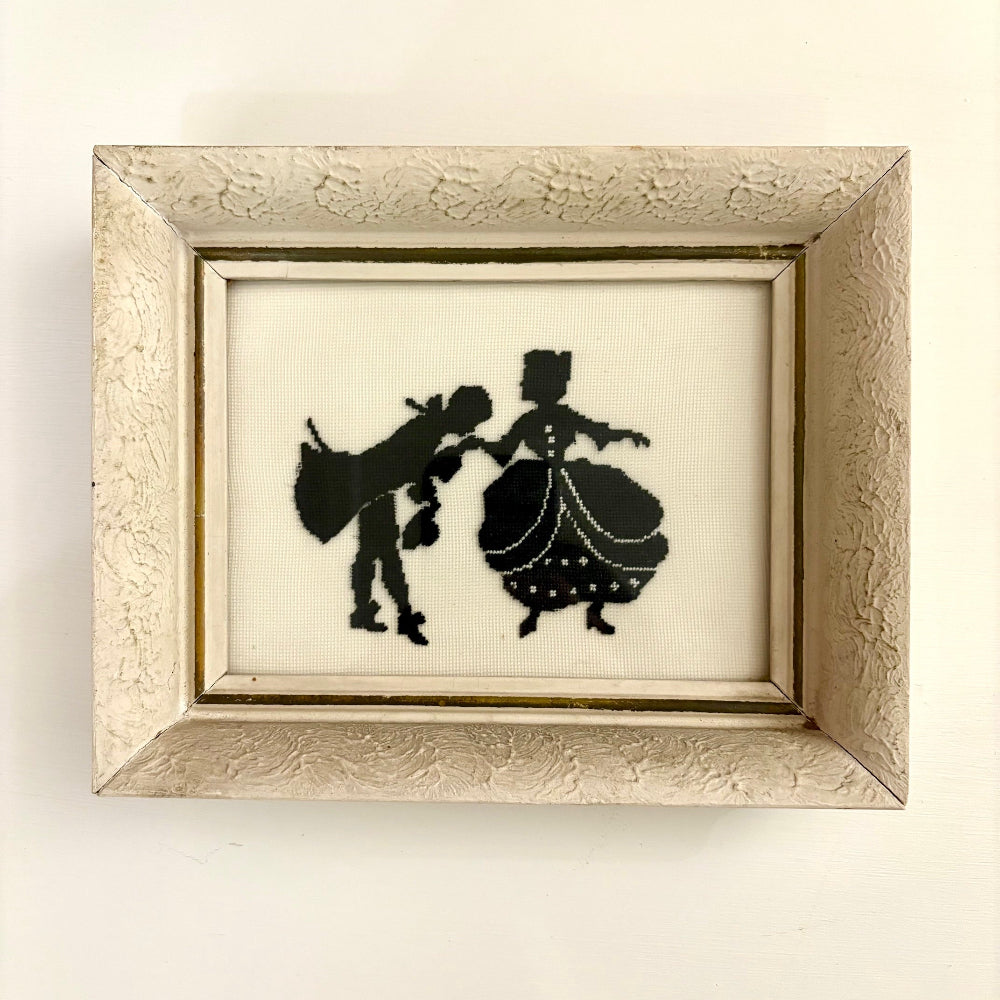 Framed silhouette art of a couple on a white background